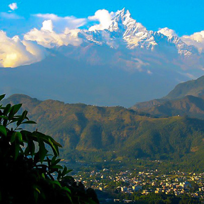 A view of the Annapurna mountain range snowy peaks and forested views along the Annapurna Foothill Trek