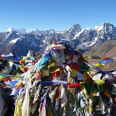 A view of colorful prayer flags in front of the Mount Everest range along the Gokyo and Mount Everest Base Camp trek